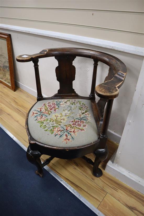 An 18th century provinicial walnut corner elbow chair (a.f.), width 74cm, height 78cm